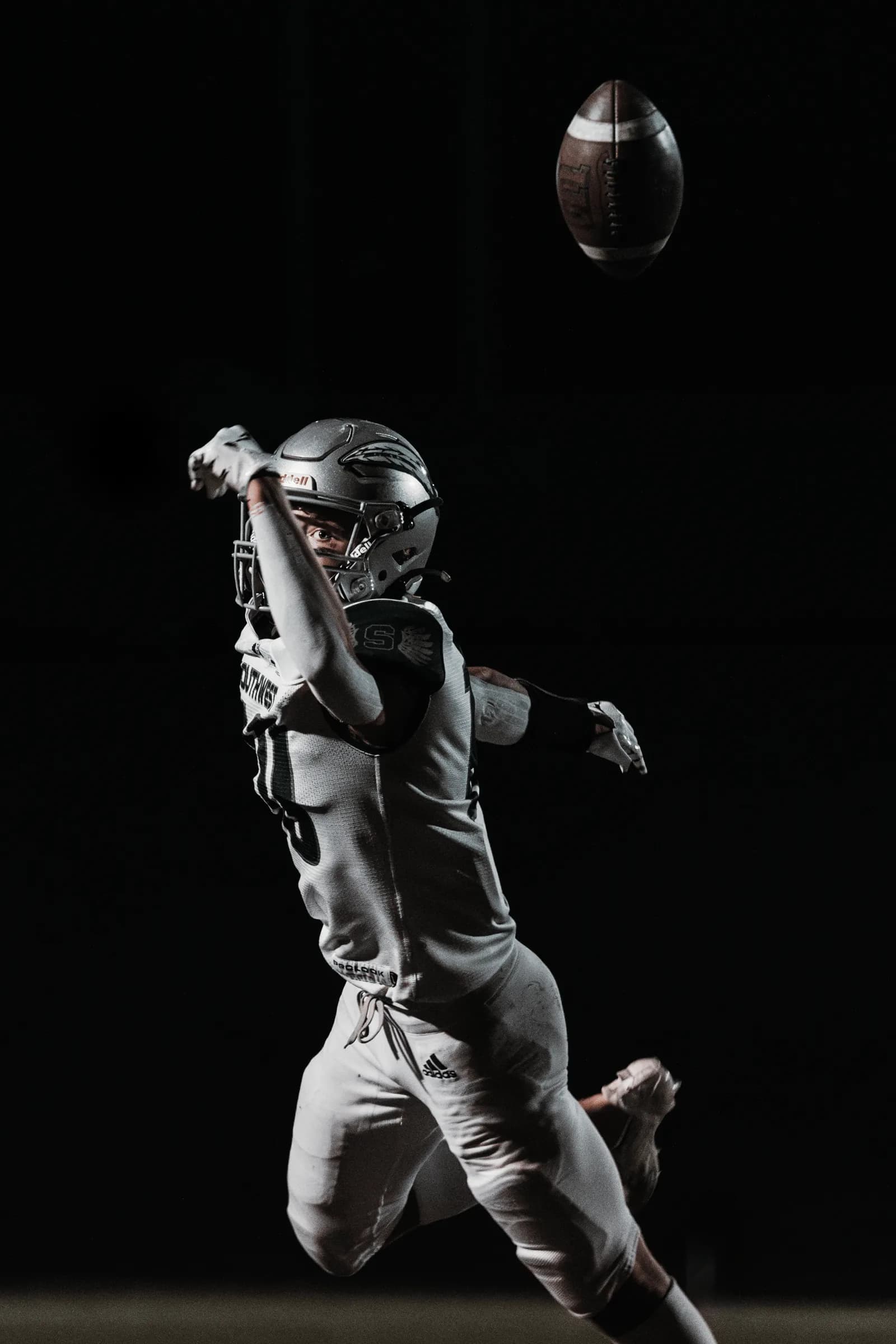 A Lincoln Southwest Silver Hawks receiver reaches for a pass that sails just beyond his reach.