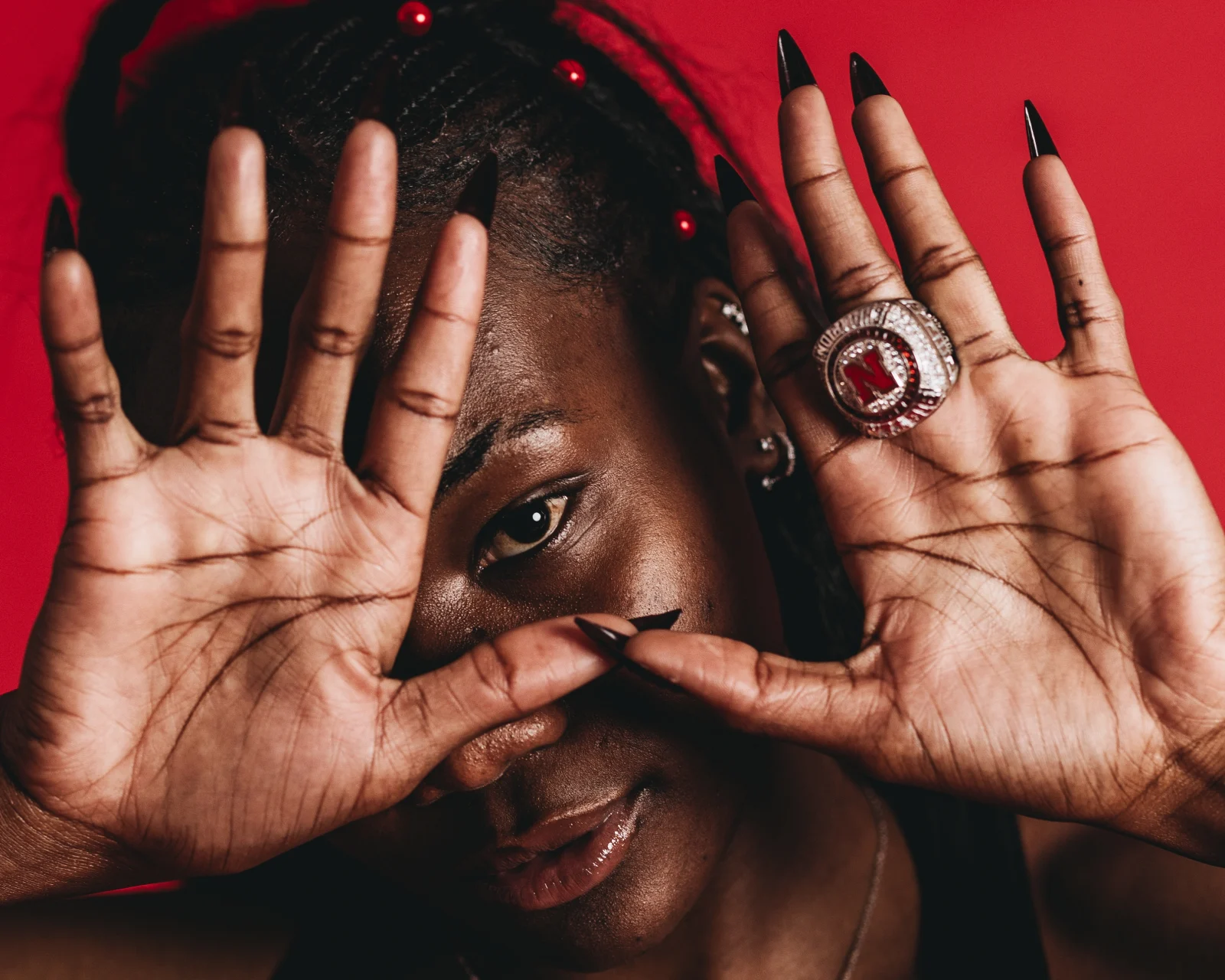 Nebraska track and field athlete Rhianna Phipps shows her Big Ten championship ring during a media day portrait session in Lincoln, Neb., in 2025. Phipps, a five-time USTFCCCA All-American, won the 2024 Big Ten outdoor triple jump title.