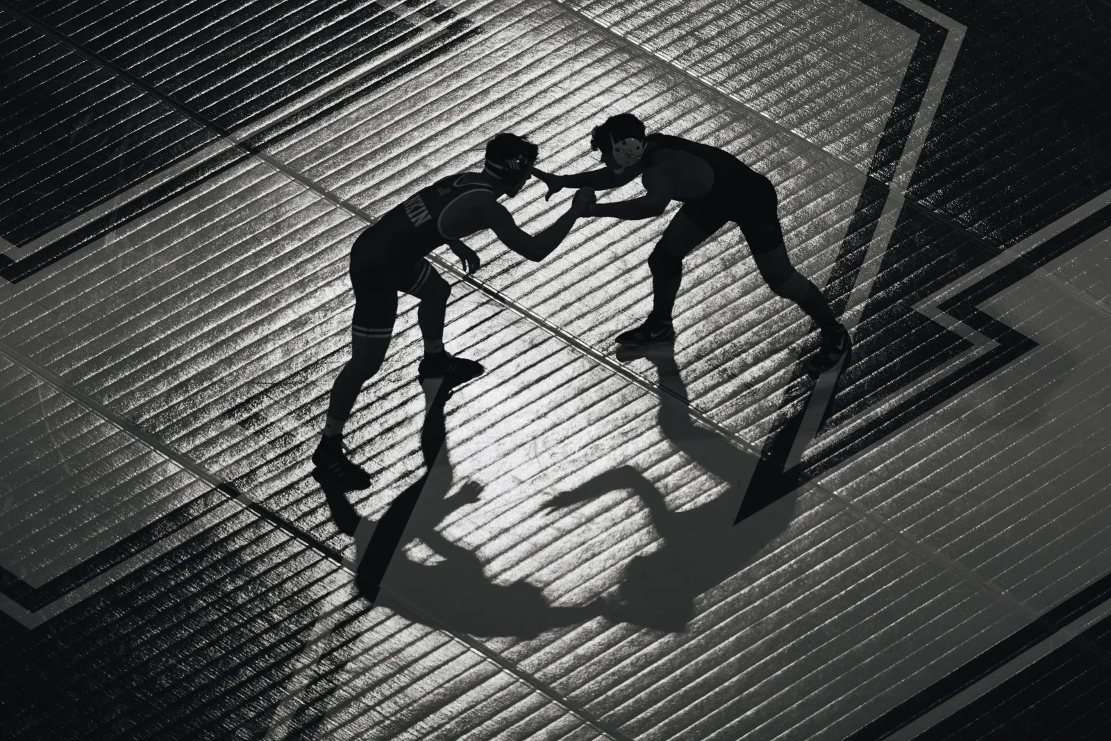 Wrestlers from Nebraska and Army grapple in silhouette during a dual at the Bob Devaney Sports Center in Lincoln, Neb., Friday, Nov. 7, 2025. No. 2 Nebraska won 33-3 in its home opener.